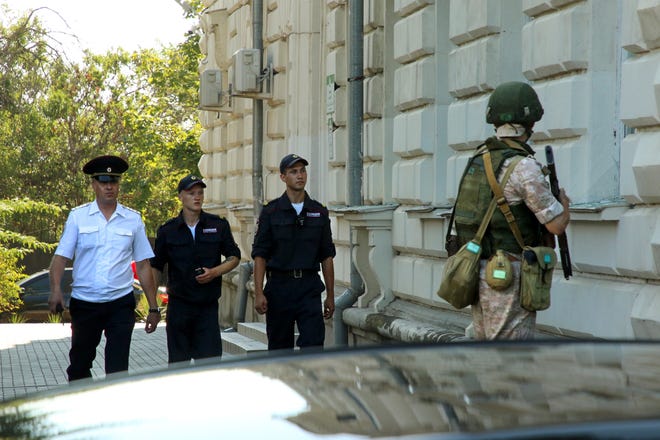 A Russian soldier guards the headquarters of Russia's Black Sea Fleet in Sevastopol, Crimea, Sunday, July 31, 2022.