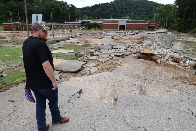 Caption: Jalen Cooper, 27, a teacher in Buckhorn, Kentucky, surveys his school damaged by the recent floods