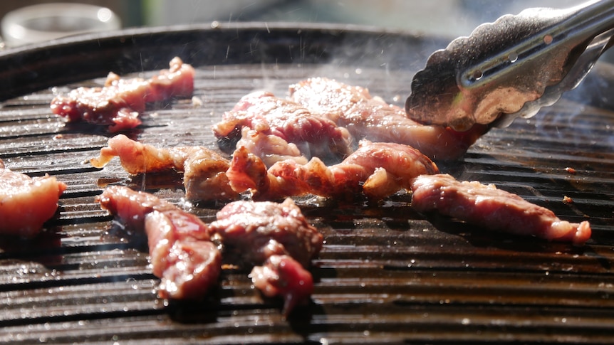 Wagyu beef cooking on barbecue.