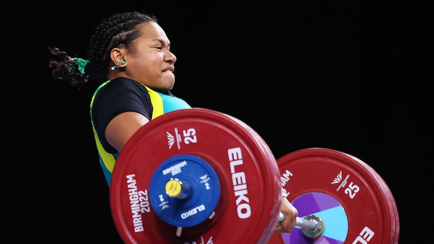 Eileen Cikamatana performs a clean and jerk