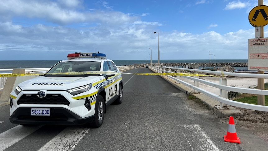 A police four-wheel drive parked across a boat ramp