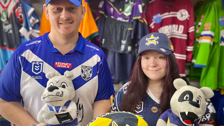 Man and woman stand in an nrl apparel store in Bulldogs and Cowboys merchandise