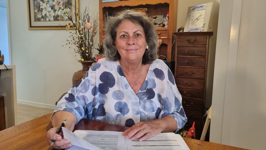 Woman with hands on table