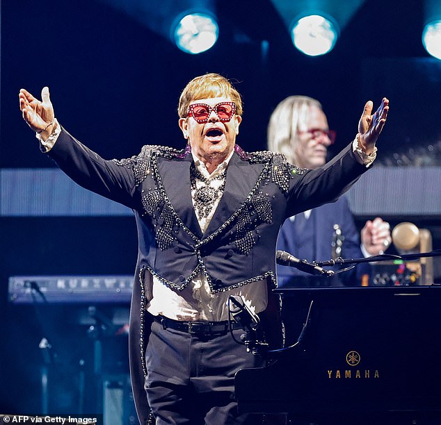He's still standing!  Elton John, 75, looked to be in fine form when he brought his Farewell Yellow Brick Road tour to Soldier Field in Chicago on Friday night