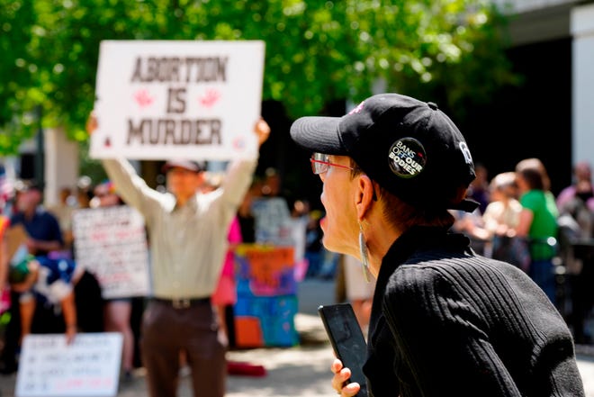 A woman supporting abortion rights shouts at anti-abortion protesters outside the South Carolina Statehouse on July 7 in Columbia, SC