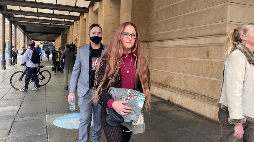 A woman leaves the District Court after giving a victim impact statement