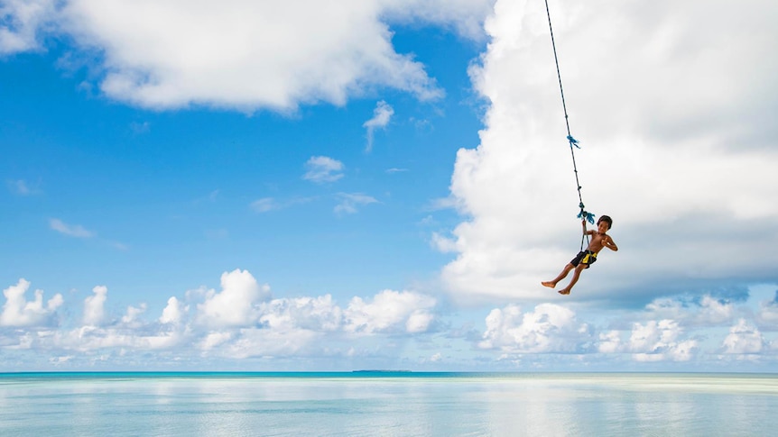 Kiribati kid on a swing