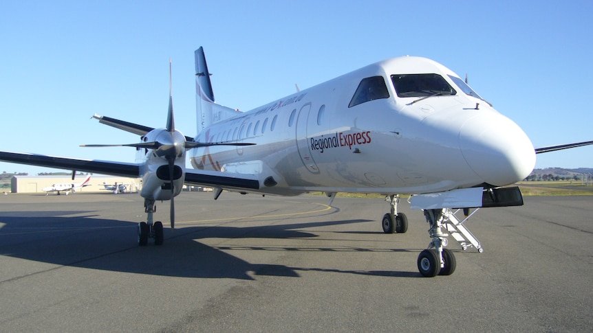A side picture on a plane sitting on a runway