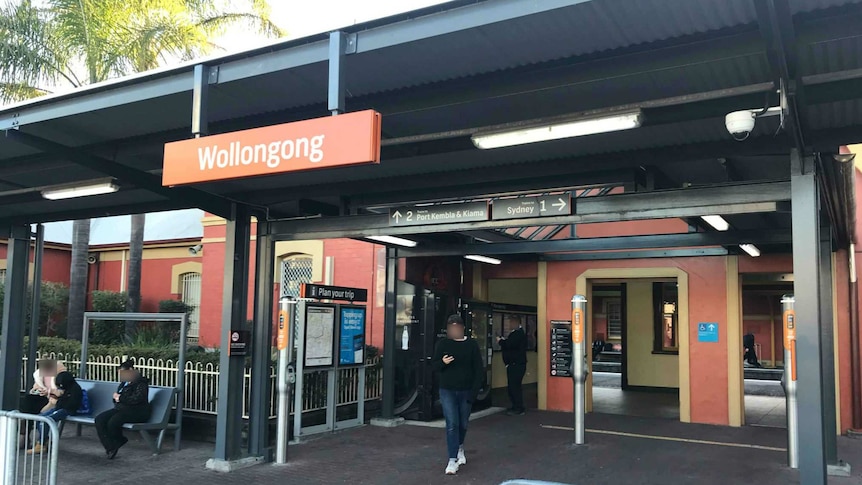 Wollongong train station in the afternoon, with commuters waiting.