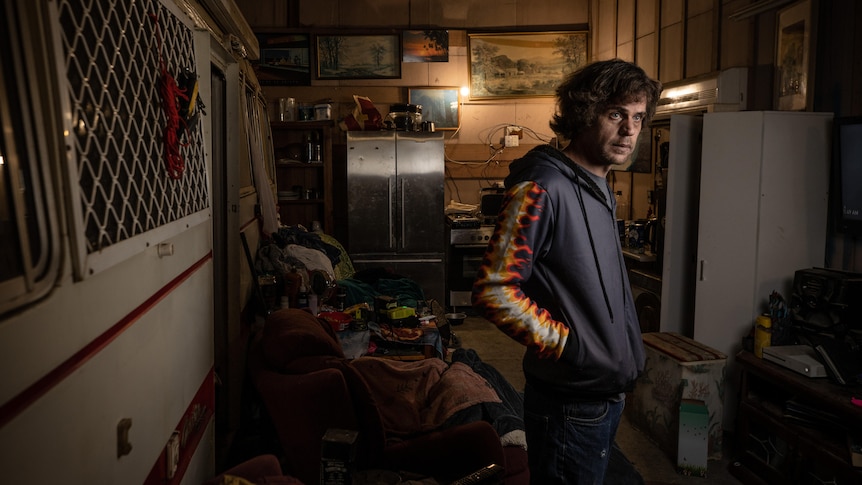 James Paul inside a shed turned into a living area.