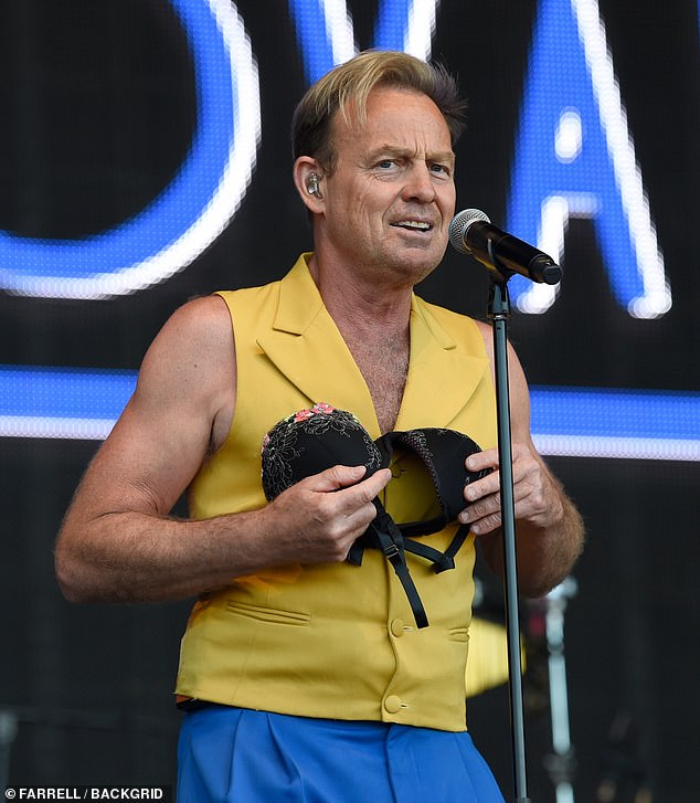Pop icon?  Jason Donovan, 54, looked puzzled as he clutched a bra on stage at Rewind North in Cheshire on Sunday after an excited fan threw their underwear at him
