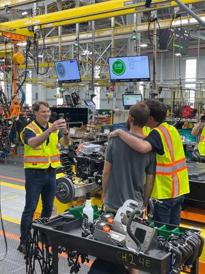 Ford CEO Jim Farley snaps a photo of "The Tonight Show Starring Jimmy Fallon" host with an arm around an F-150 Lightning worker at the Rouge Electric Vehicle Center in Dearborn on Friday, Aug. 5, 2022.