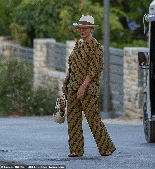 Safari-style!  Kylie Minogue cut a stylish figure in a printed two-piece ensemble and clutched a $1,170 Loewe beach bag as she holidayed in Croatia on Wednesday
