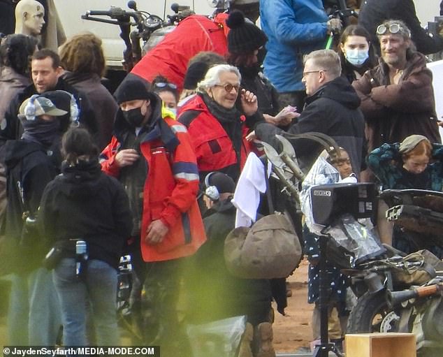 George Miller (centre) isolating with Covid at his Sydney home