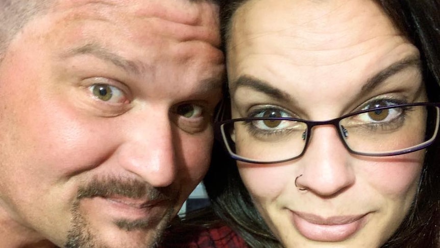 A close up of a man and a woman posing for the camera