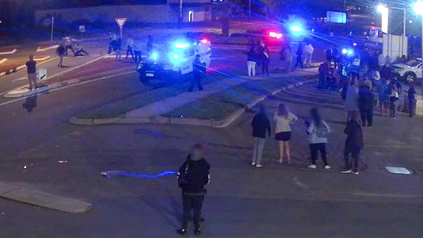 Police at the scene of a melee outside a pub.