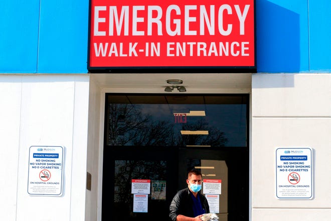 A healthcare worker exists from to the emergency room at Hudson Regional Hospital in Secaucus, New Jersey, on December 11, 2020.