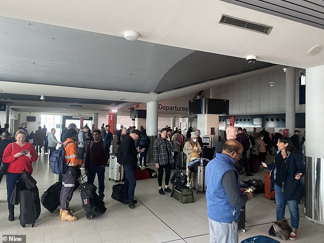 Departing passengers faced lengthy delays in checking in luggage due to a power chaos (pictured, affected travelers at Perth Airport on Tuesday)