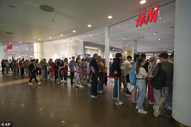 Russian shoppers wait to buy their last items from H&M in a Moscow shopping center before the retailer closes its Russian stores