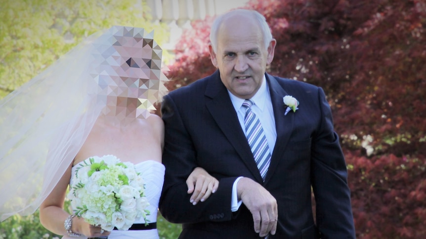 Man escorts a bride, whose identity is obscured, at a wedding.